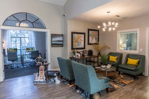 a living room with a table and chairs and a large window